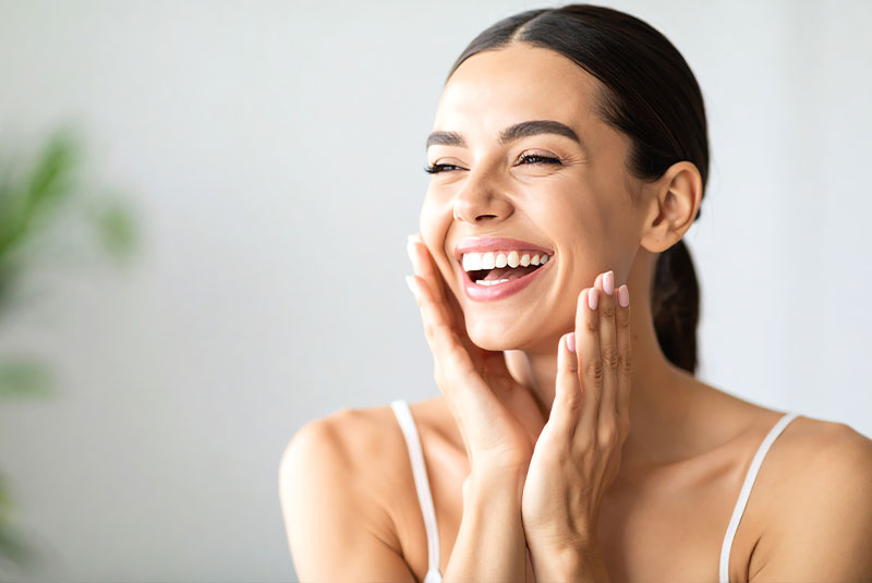 beautiful women smiling brightly with glowing radiant skin