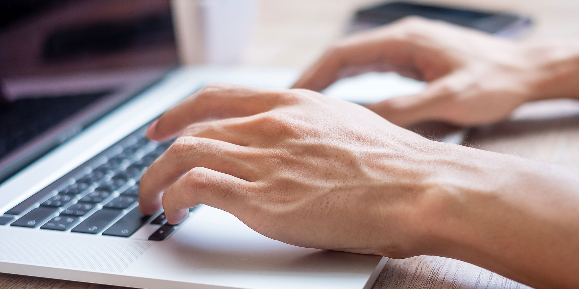 close up of person writing a blog on their laptop