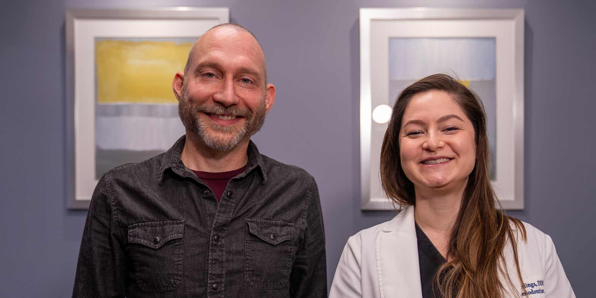 doctor and patient smiling both within the dental center after dental implant procedure