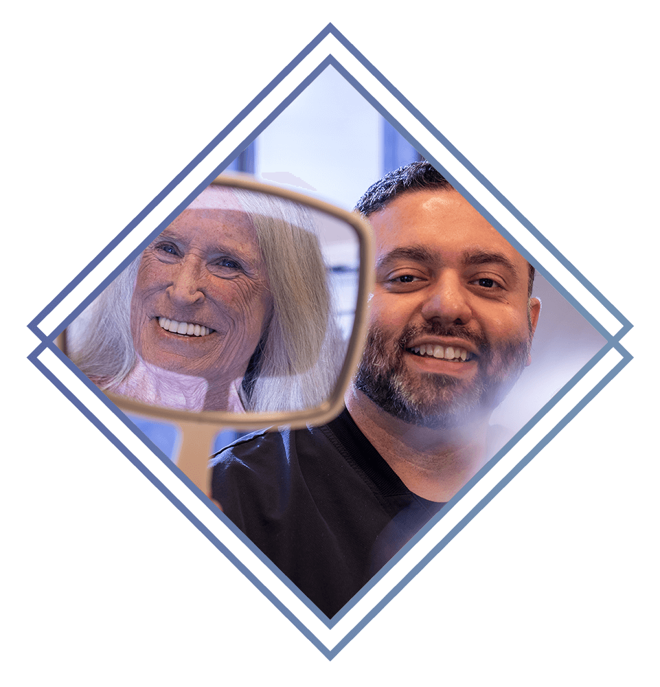 doctor showing mirror to patient and patient smiling brightly