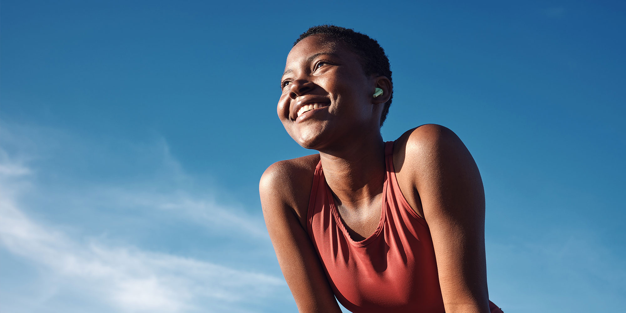 woman and happy athlete smile after running, exercise and marathon training workout.
