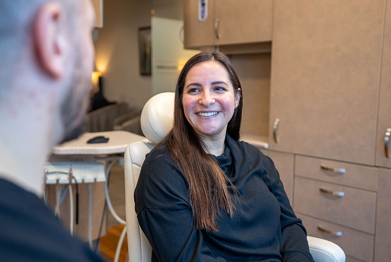 patient and doctor going over dental treatment information within the dental center