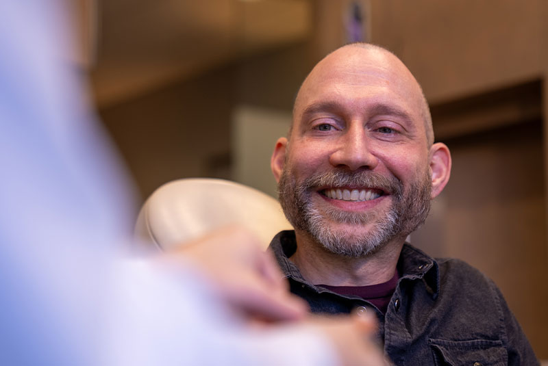 patient smiling brightly after their dental implant treatment
