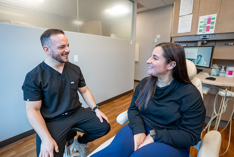 patient and dotor talking about dental treatment within the dental center